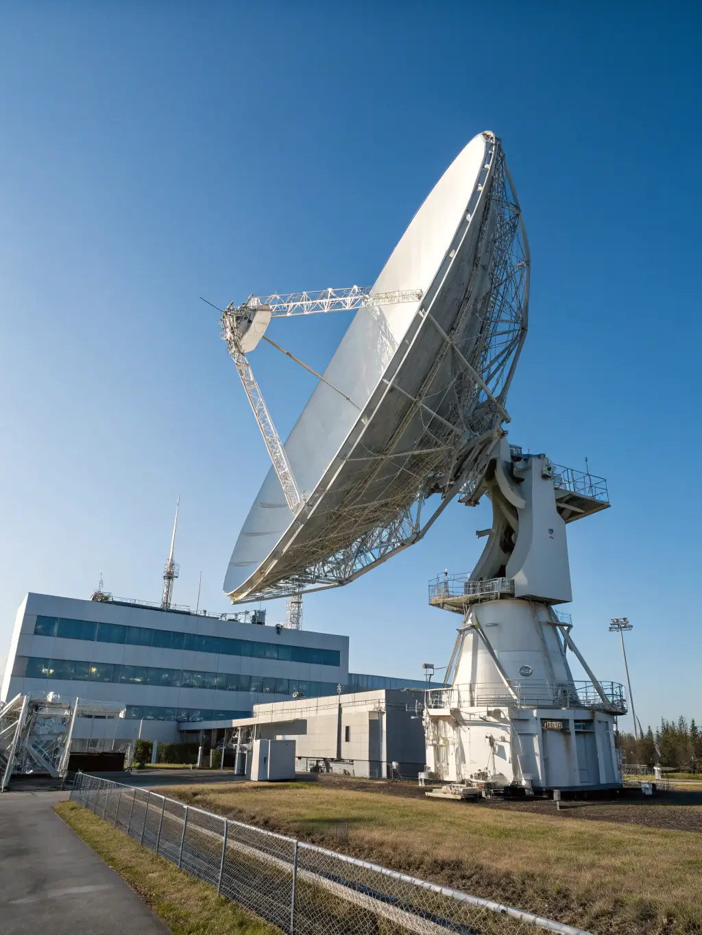 A high-tech satellite dish against a backdrop of Earth, symbolizing global telecommunications infrastructure and Nooreddin's investments in this sector.